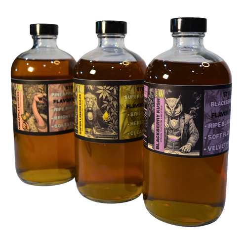 Three bottles of alcohol with decorative labels on a white background